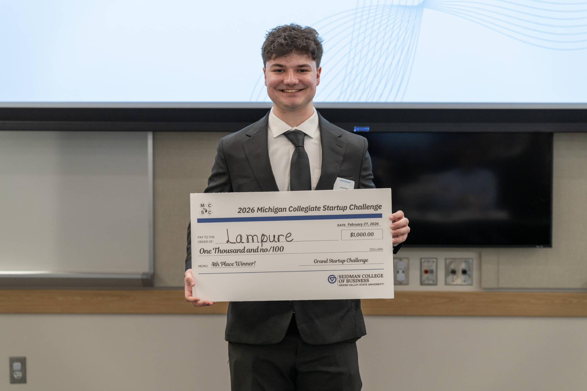 Representative of Lampure with their prize check